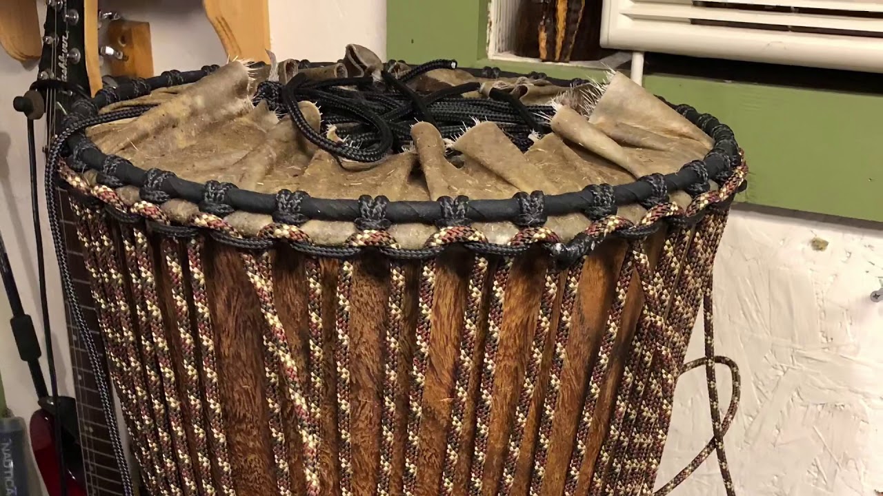 Shaving Goatskin on a Djembe.