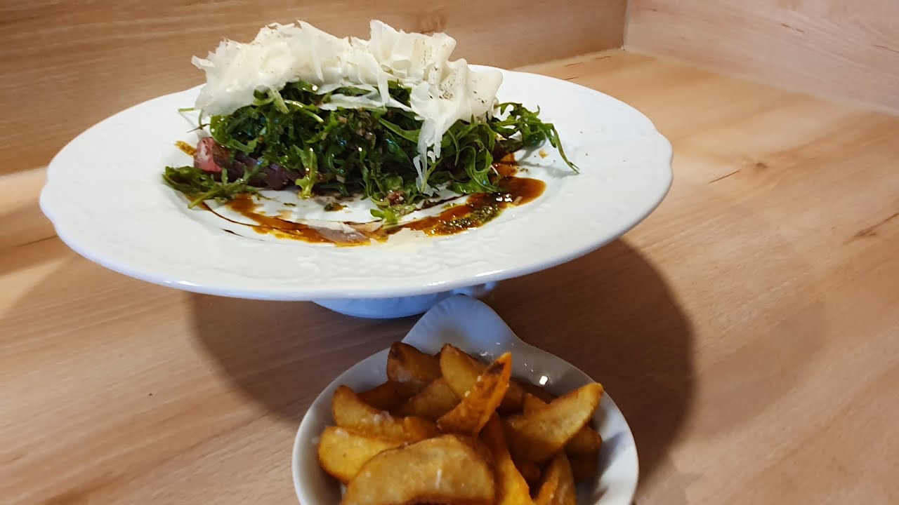 Tagliata vom Rind mit Rucola und Parmesan dazu Kartoffelspalten mit Parmesan, Meersalz und Trüffelöl