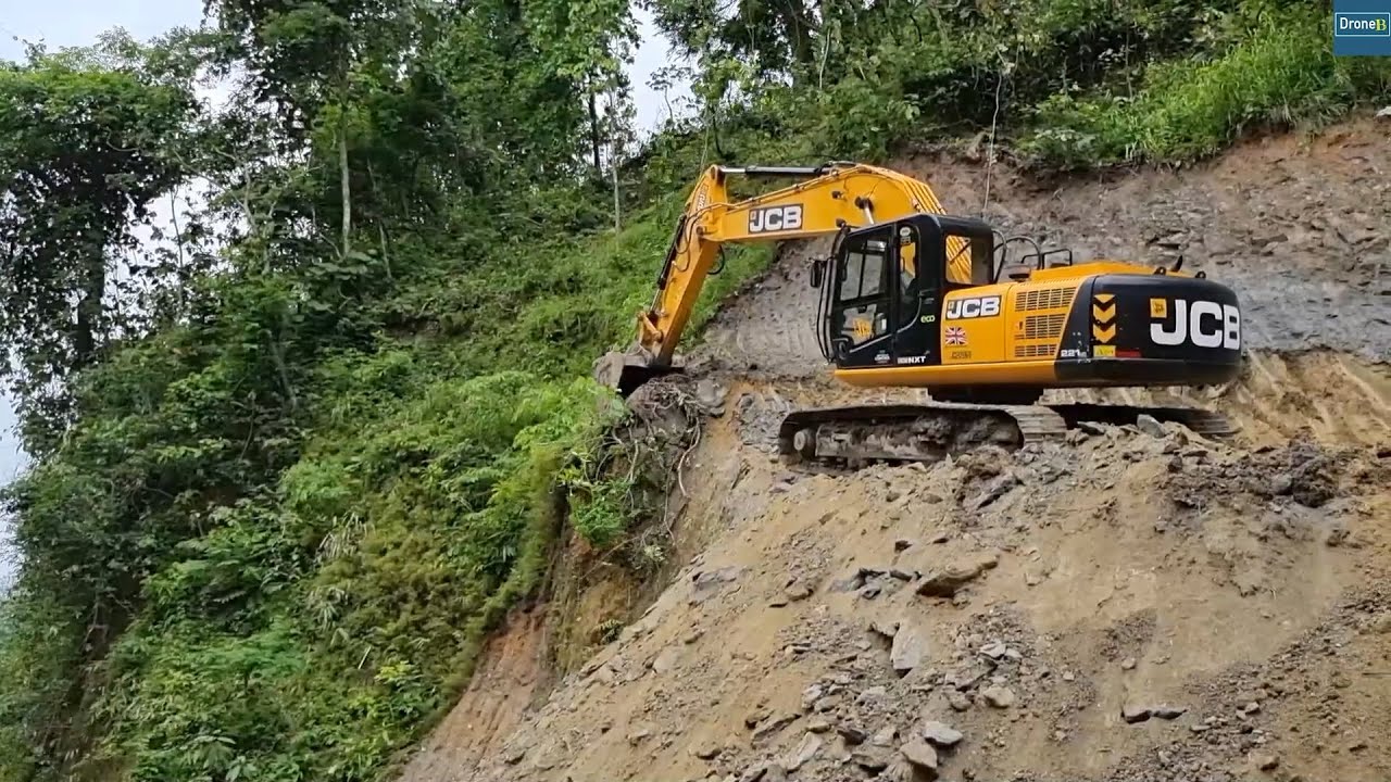 JCB Excavator and Wheel Loader Excavating Mountain Highway