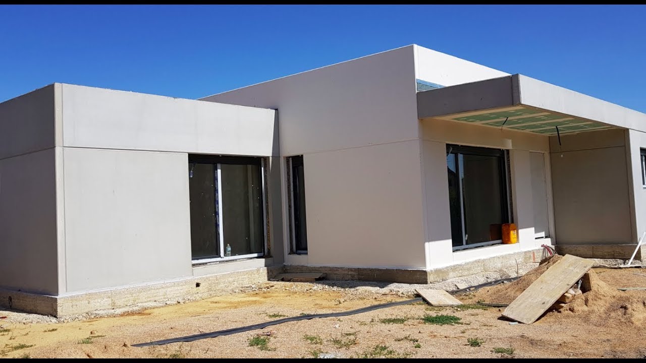 Vivienda Personalizada en Hormigón Gris y Blanco en planta baja