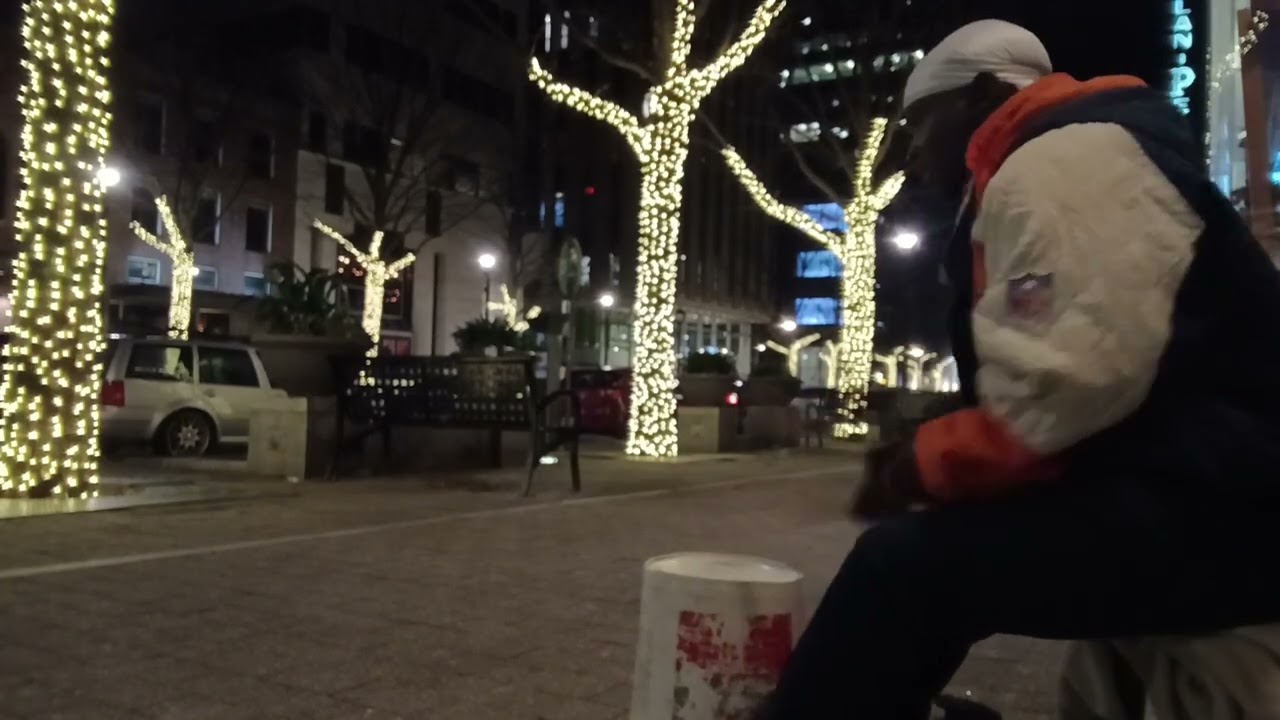 STREET DRUMMER GROOVING MAKING THE PEOPLE MOVE TO THE BEAT .