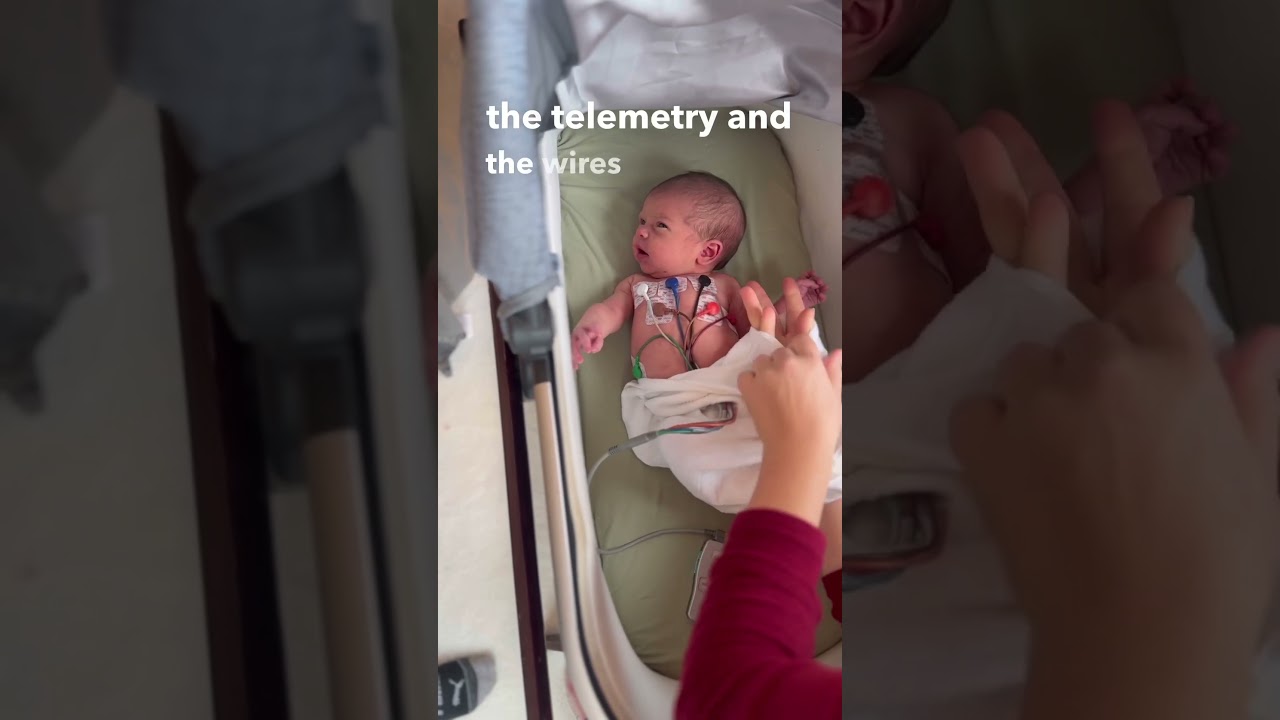 Newborn with accessible #swaddelini #babyheartbeat #whyswaddle
