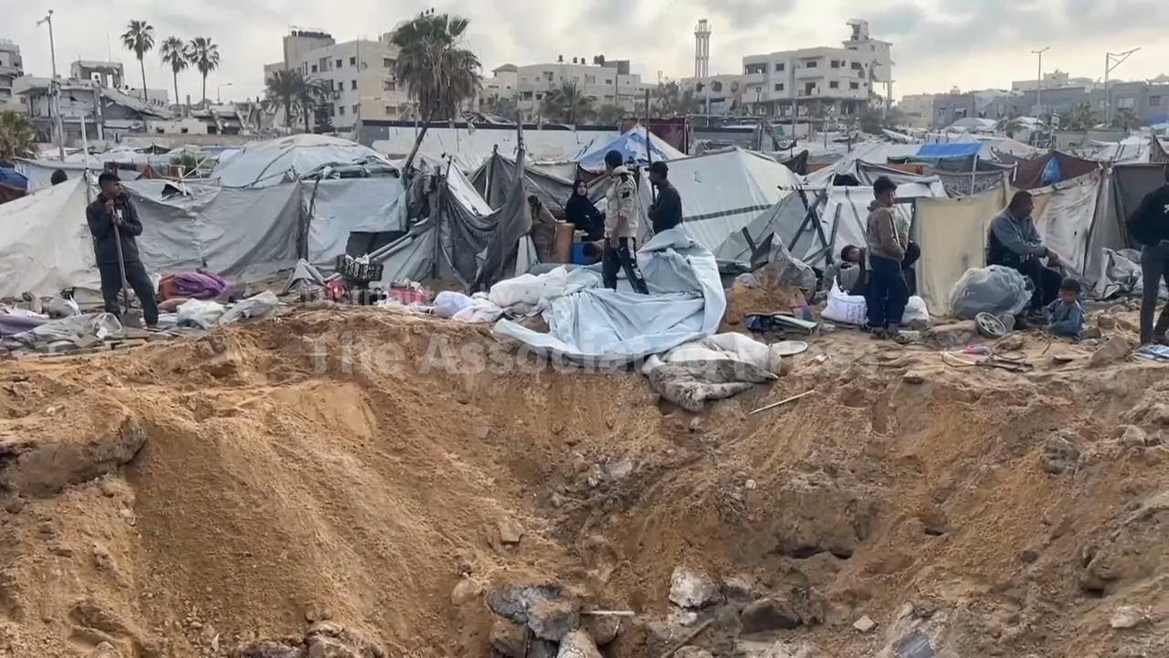 Displaced Palestinians in Gaza return to a tent camp that was struck by Israel the day before