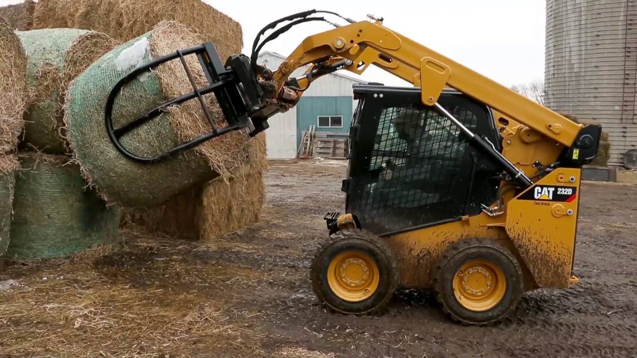 Cat&reg; Bale Grab Attachment at Work