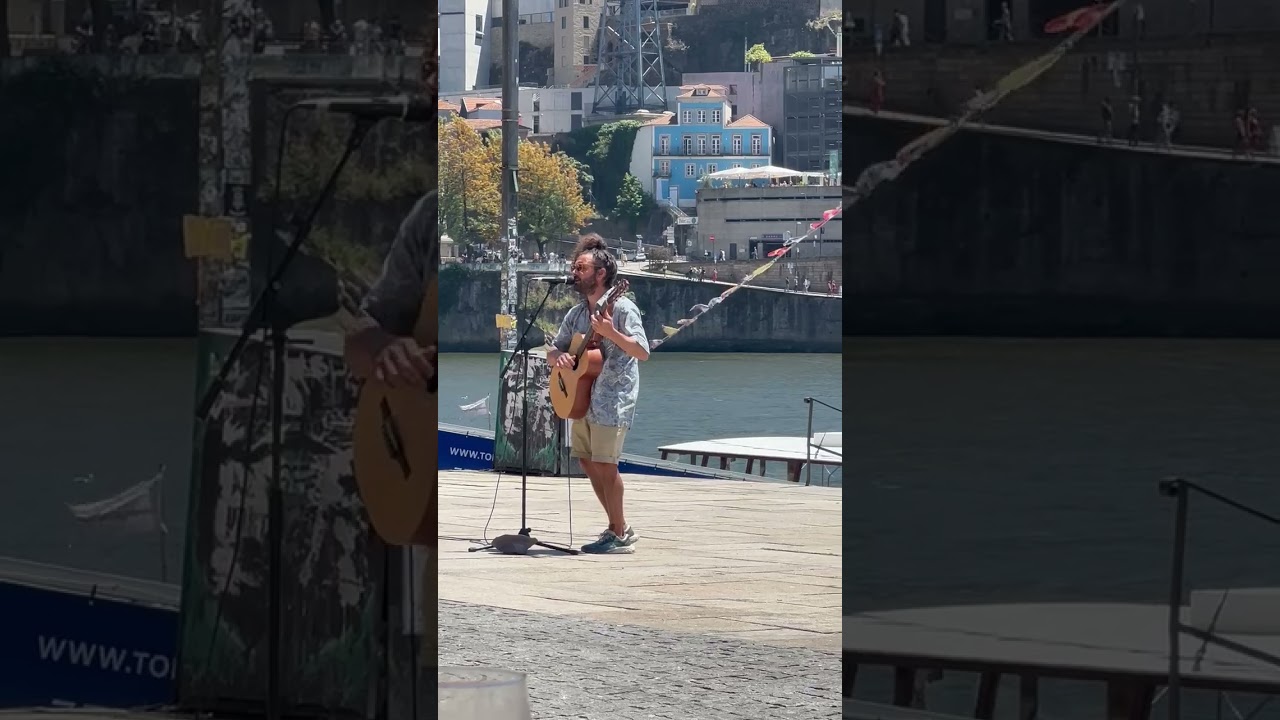 A street busker along the Cais da Estiva promenade, Porto, Portugal