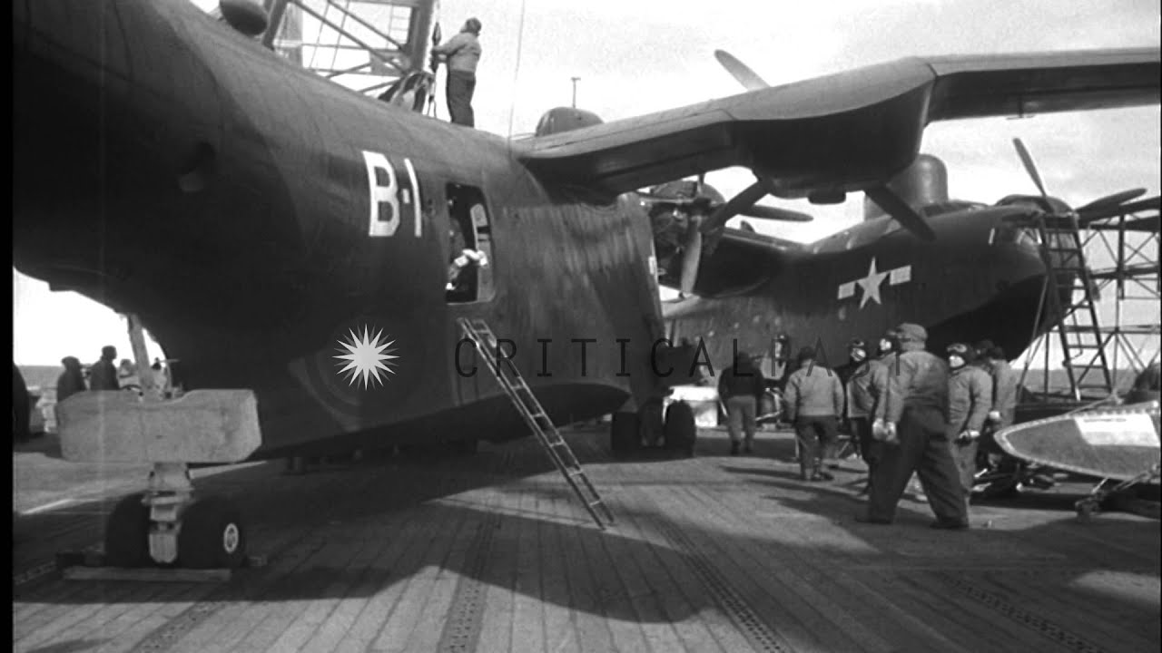 A PBM-5 Mariner is hoisted off the deck of USS Henderson and lowered into water o...HD Stock Footage