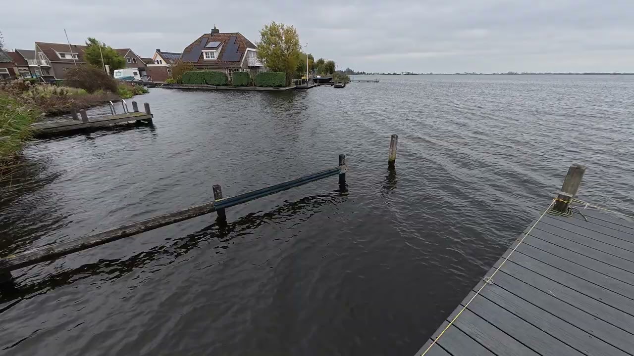 A deck and a lake, in a town
