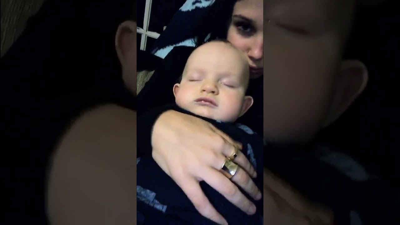 Millie Bobby Brown snuggling a baby