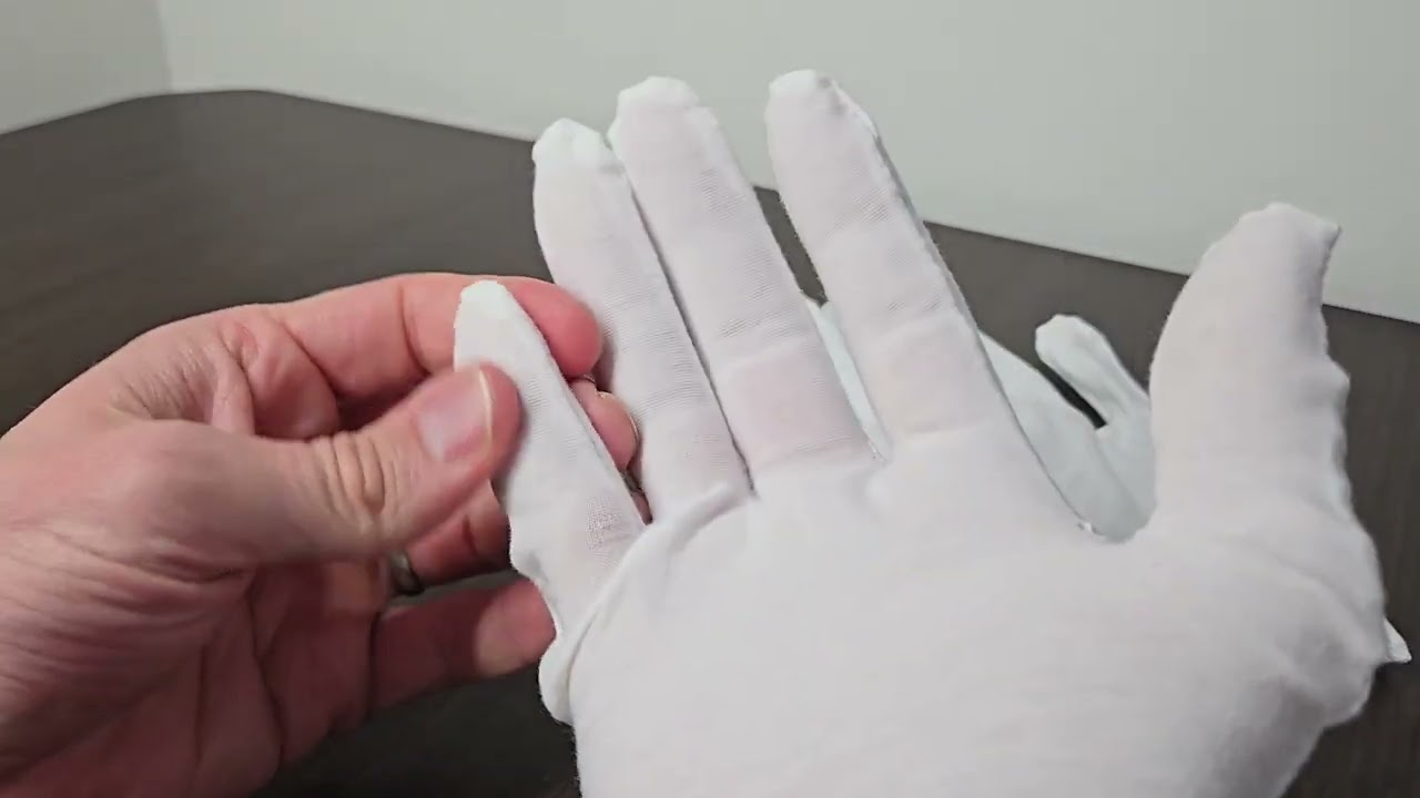 White cotton gloves for moisturizing cracked fingertips with lotion