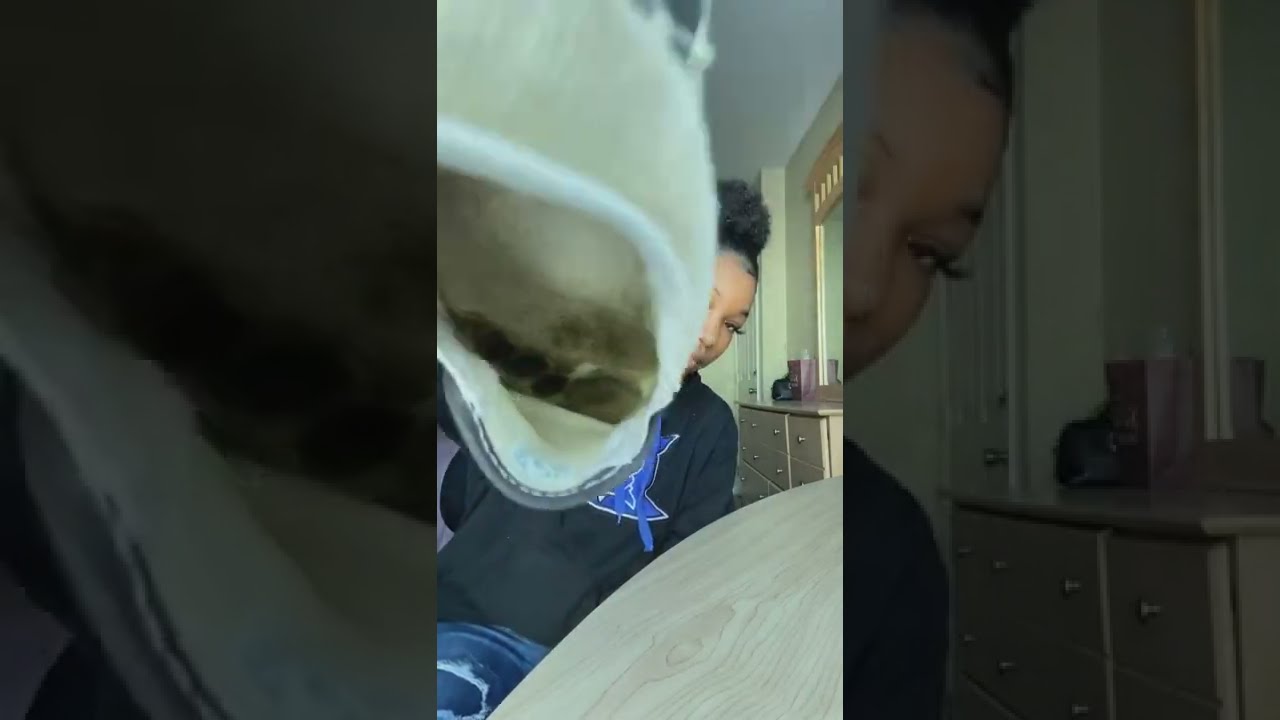 Young black women shows insoles of her very worn vans