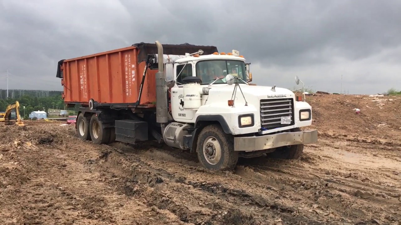 Mack roll off truck stuck in the mud at the landfill