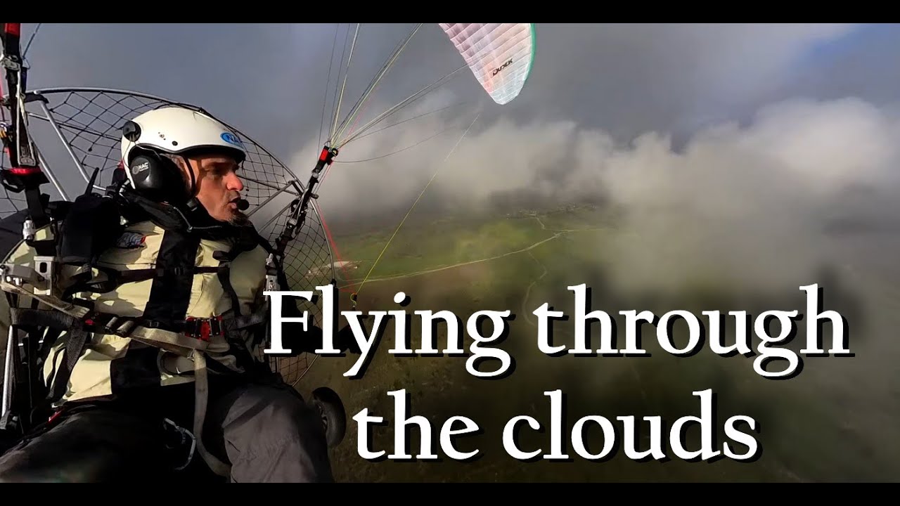 Flying through the clouds on a paramotor trike (PPG) near Madrid (Spain)