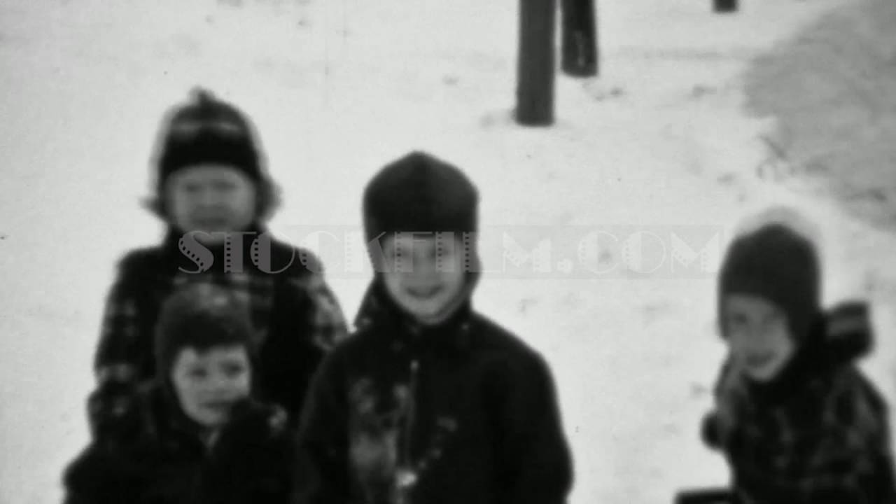 1937: Pack of rascal kids bundled for cold weather winter snow. MINNEAPOLIS, MINNESOTA