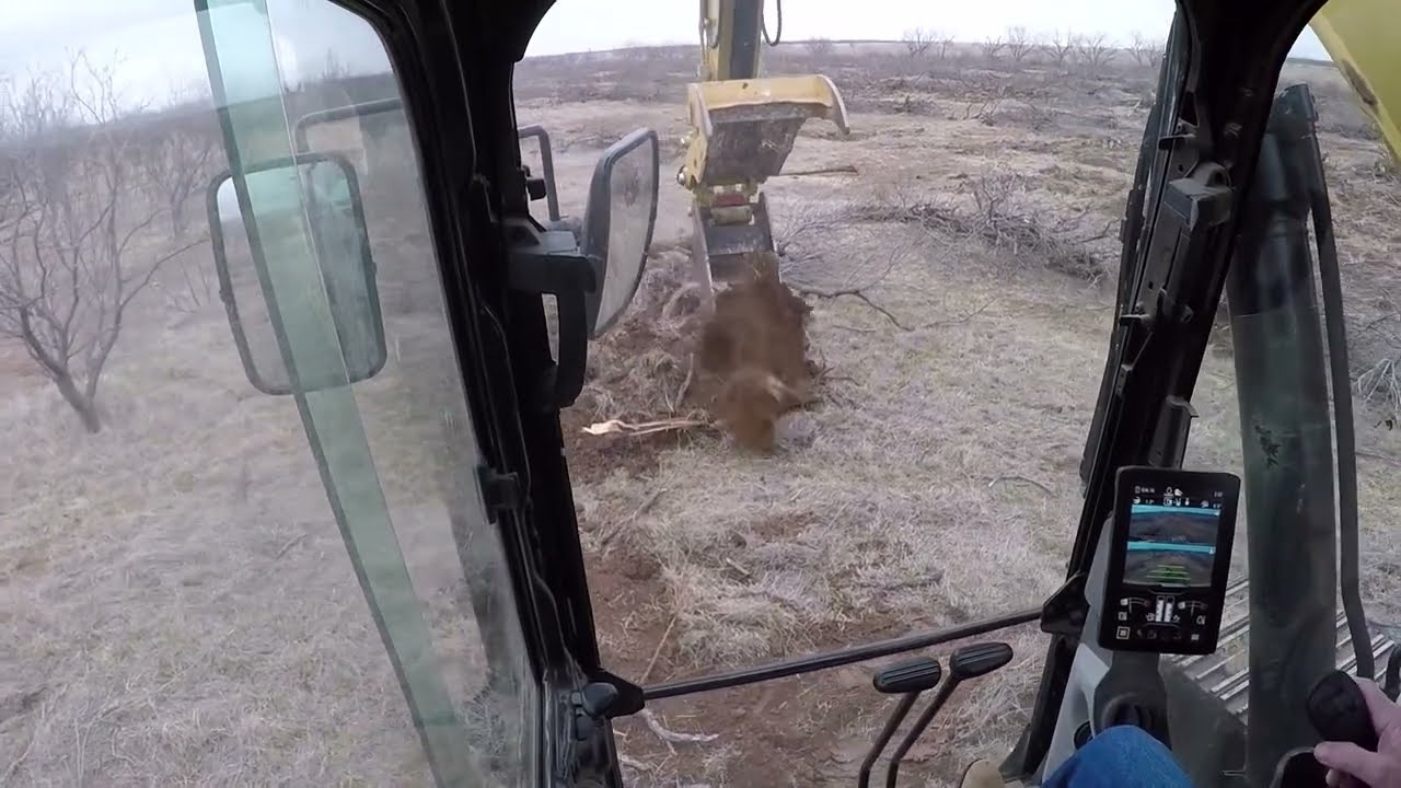 Grubbing with a 320 Cat Excavator