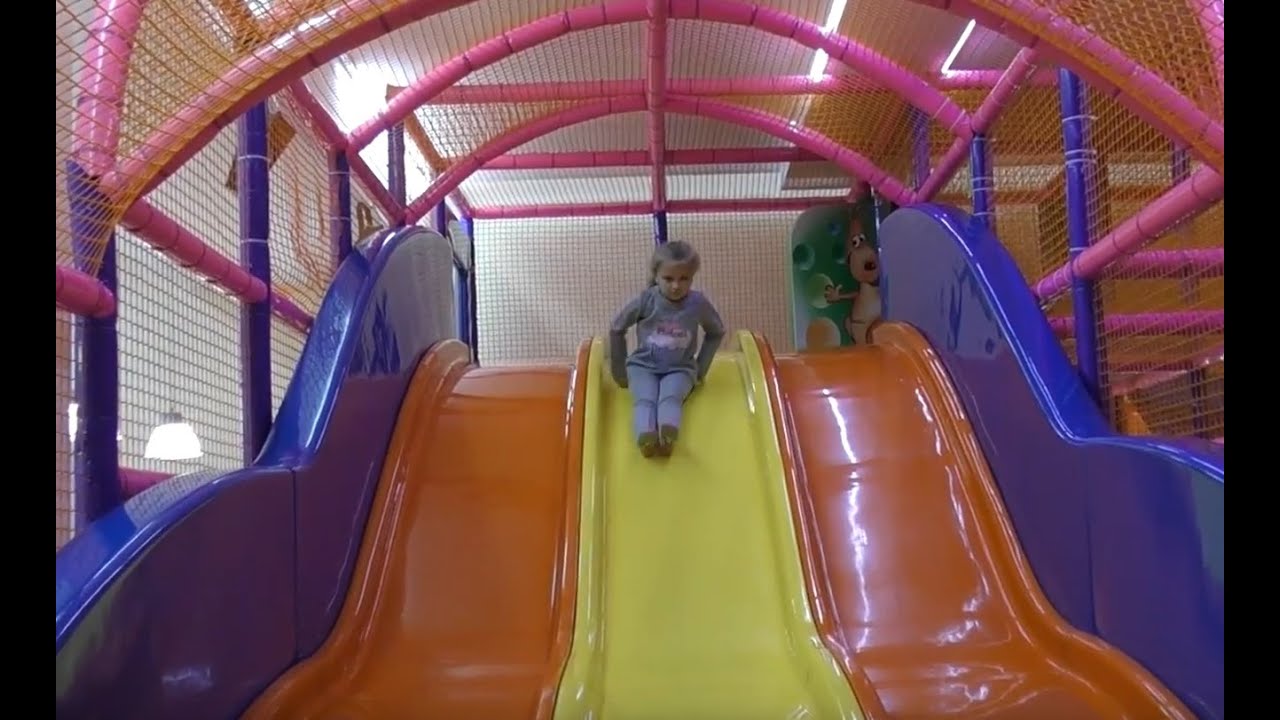 Funny girl collects multicolored pyramid at the Children's Centre