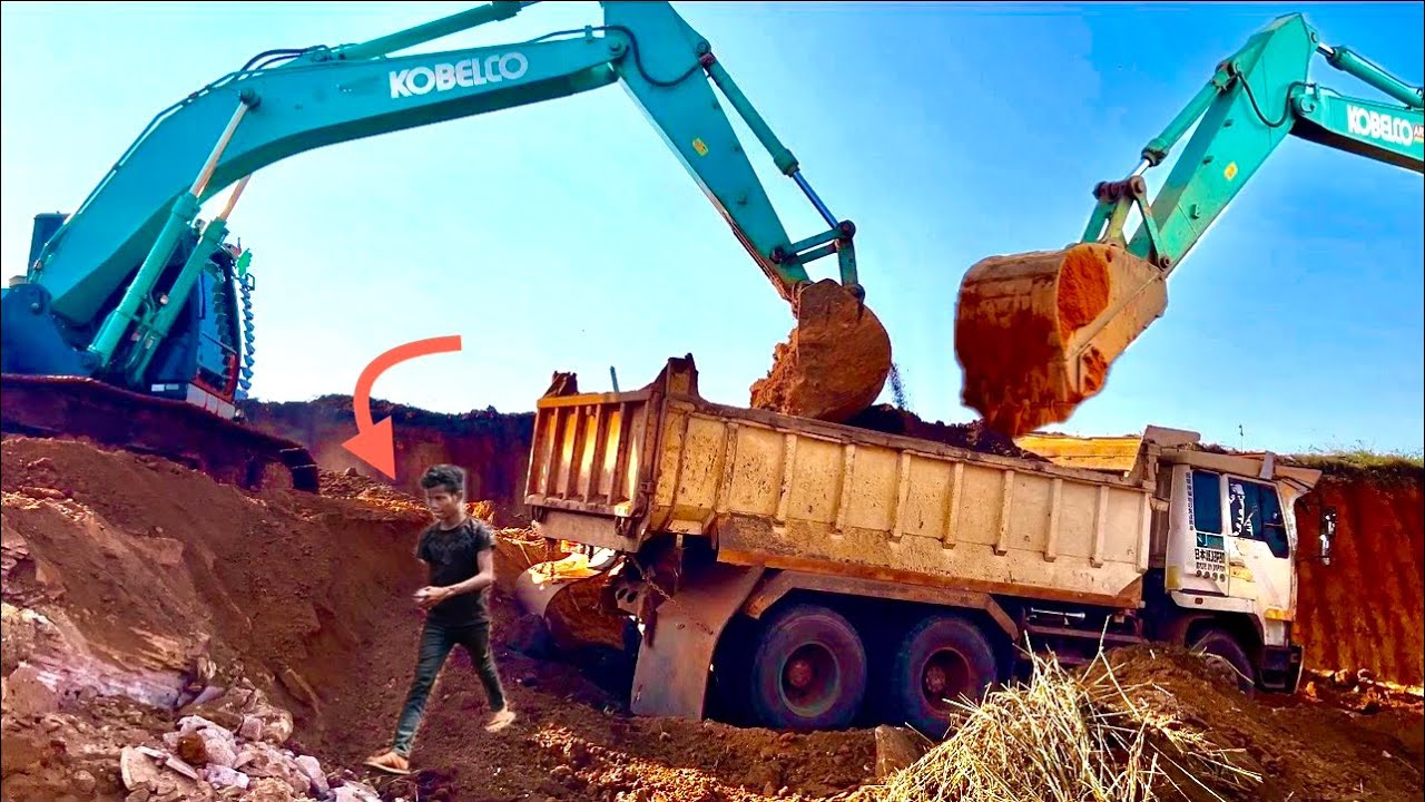 The Excavator driver waited for the earth moving truck for so long that he wanted to fall asleep