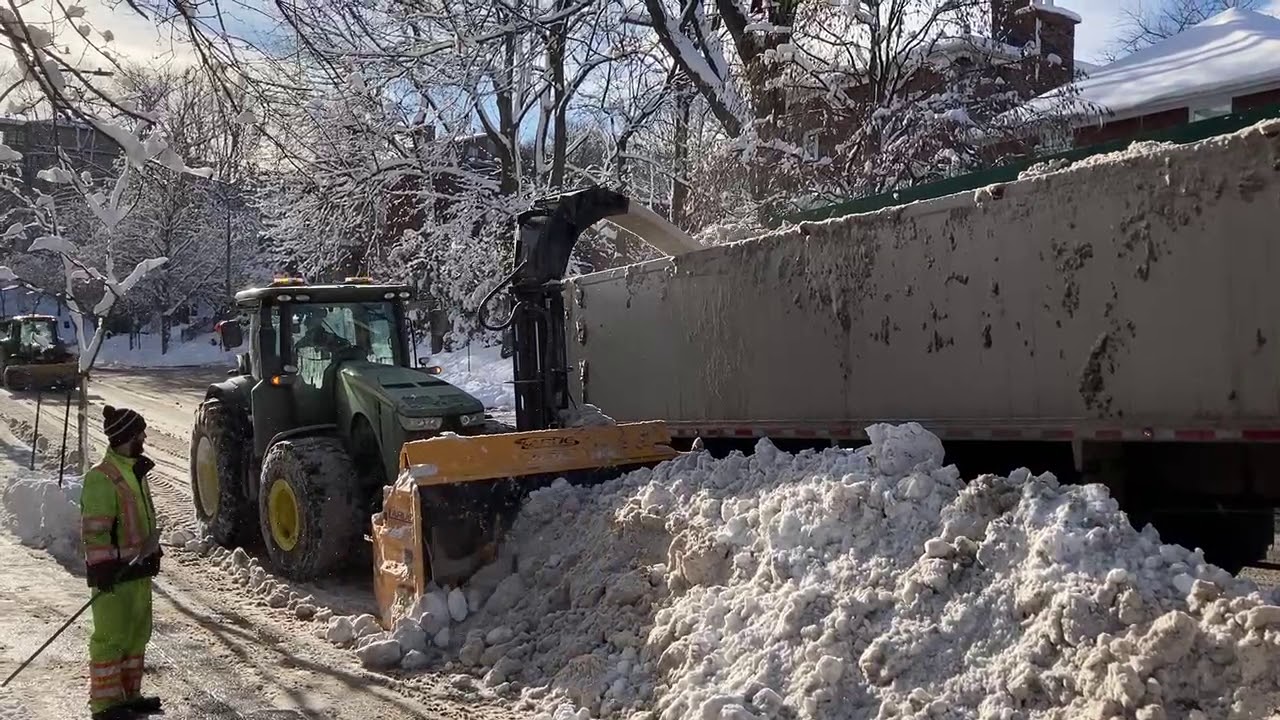 Larue R36 heavy-duty tractor-mounted snow blower loading a truck