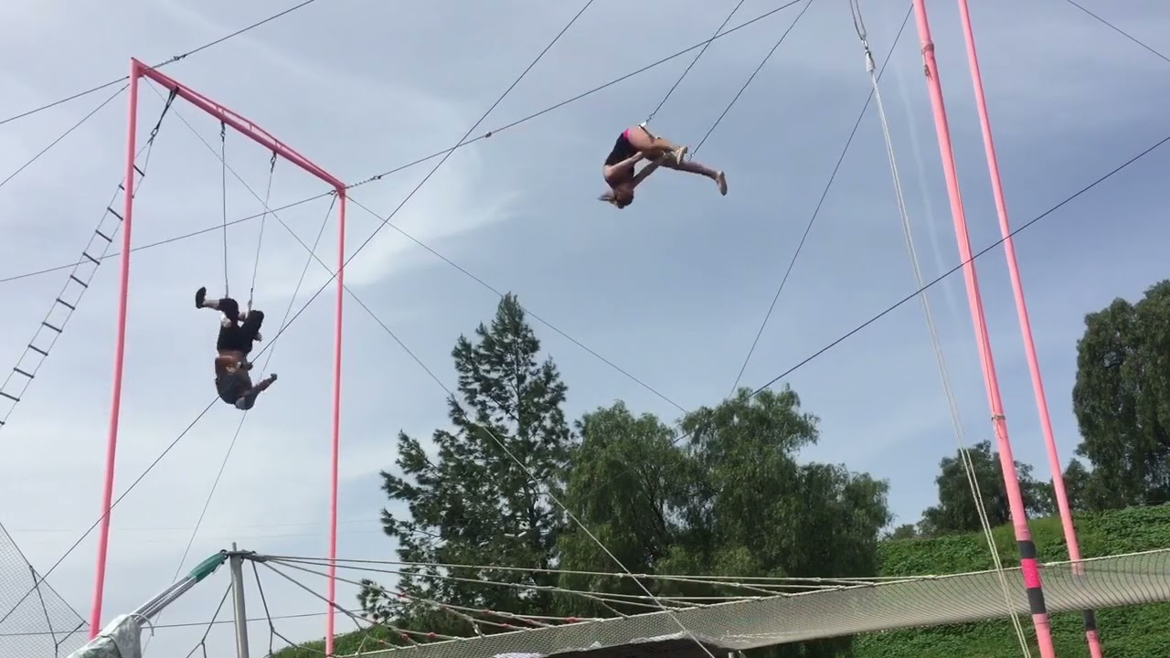 A penny roll on the flying trapeze with a return 