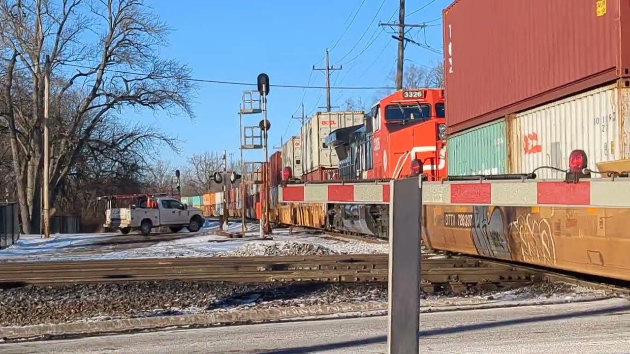 Northbound CN Intermodal on the leghtion sub at West Chicago with a special red boxcar at the end