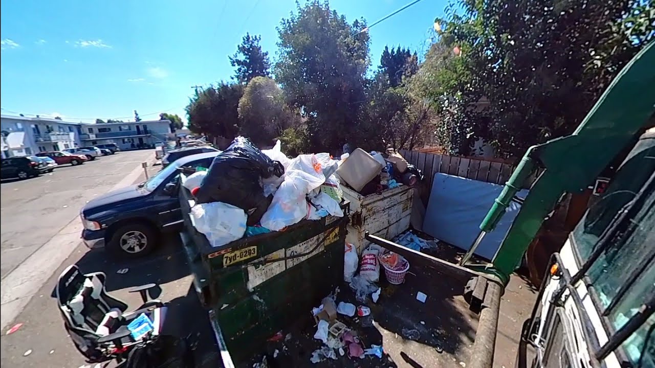 COMPILATION of Waste Management commercial garbage trucks dumping full bins. 