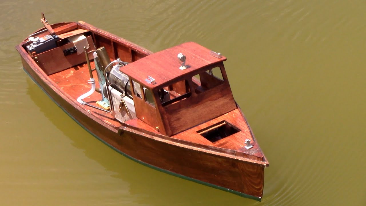 Homemade wood R/C Steamboat model under way R/C with live steam engine on the lake