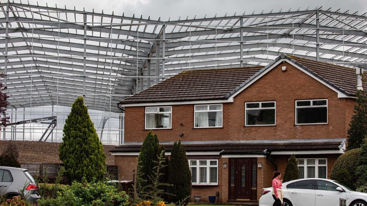 "It's like a cruise ship in our garden": New 60ft warehouses loom over homes | SWNS