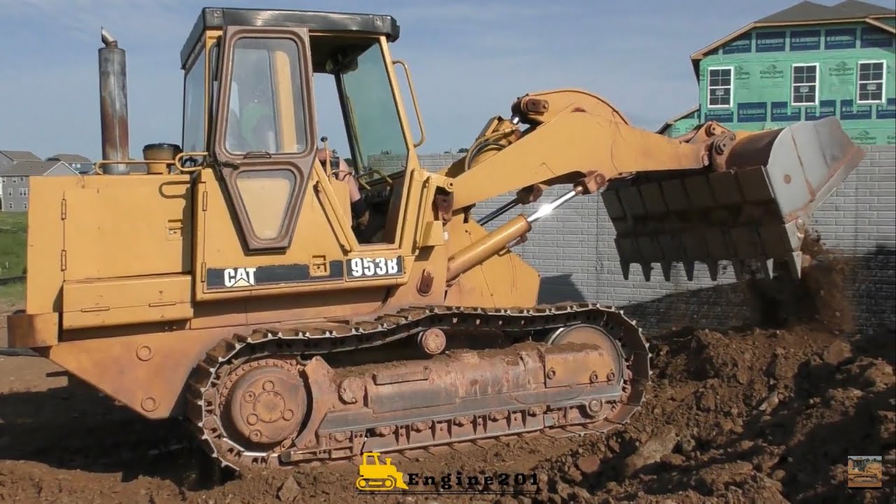 Caterpillar 953B Unloading and Beginning a Backfill