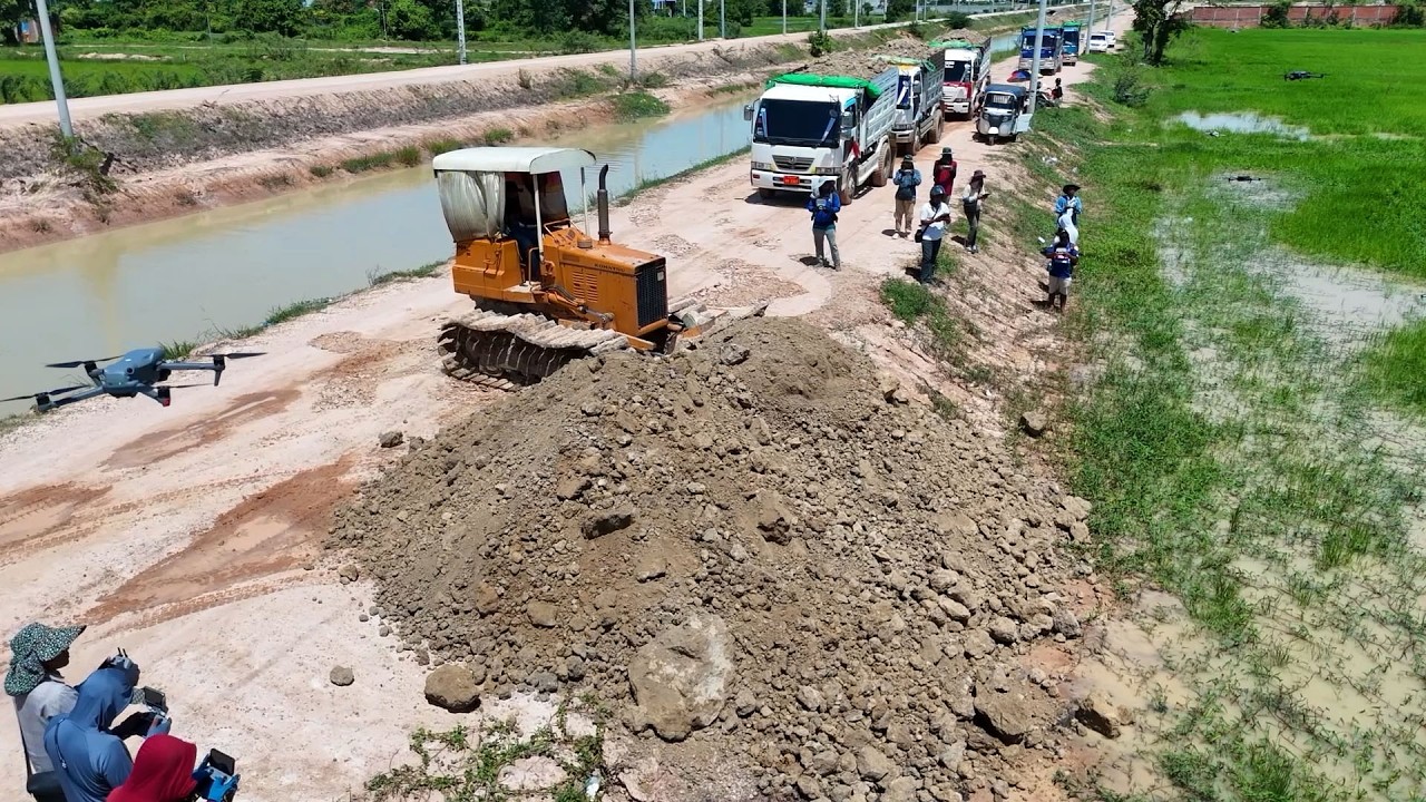 Great Start!! Action with the Komatsu dozer and Dump Trucks working together to move stone and soil