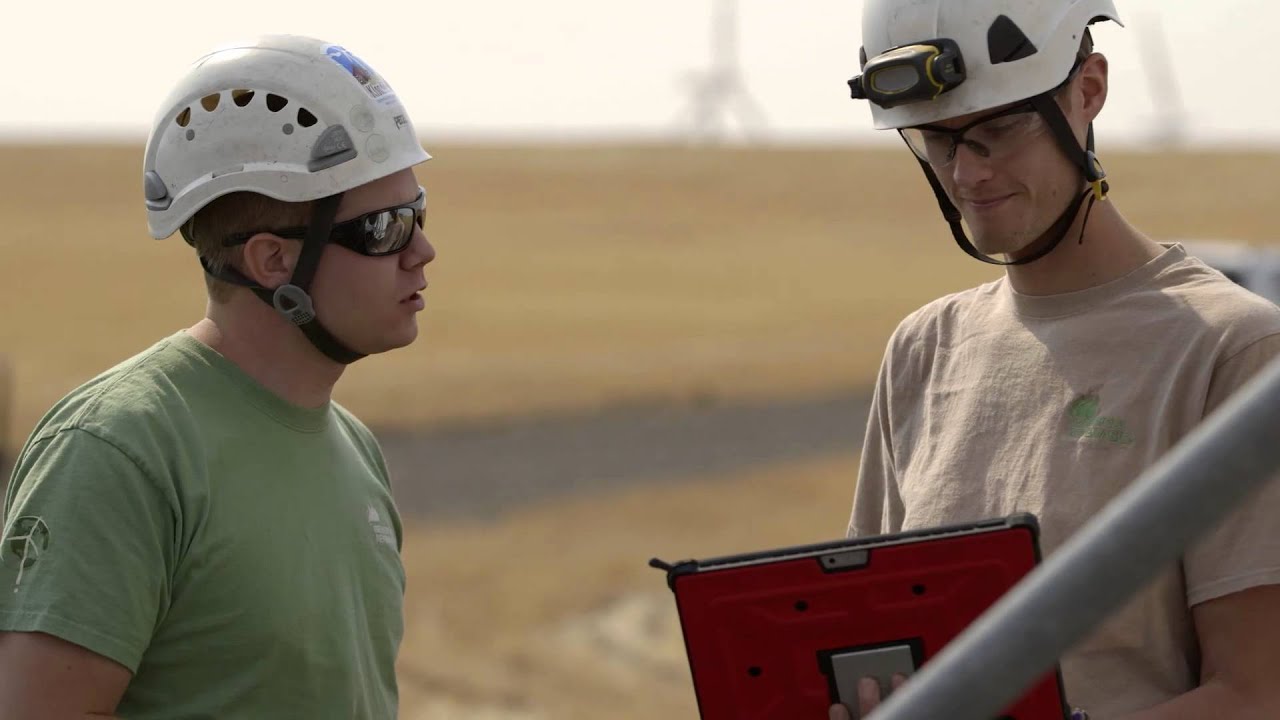 Wind Farm Technicians and High-Tech Tablets at Work