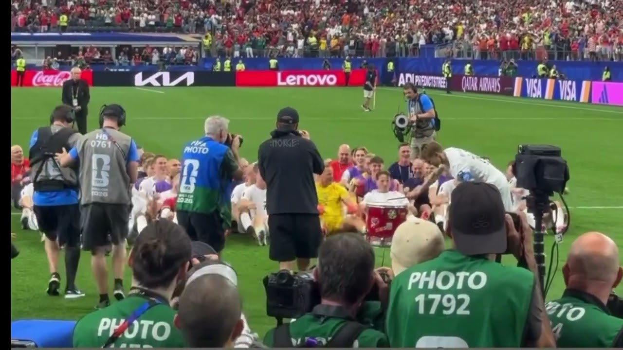Norway fans and players celebrate together with the iconic rowing celebration. 