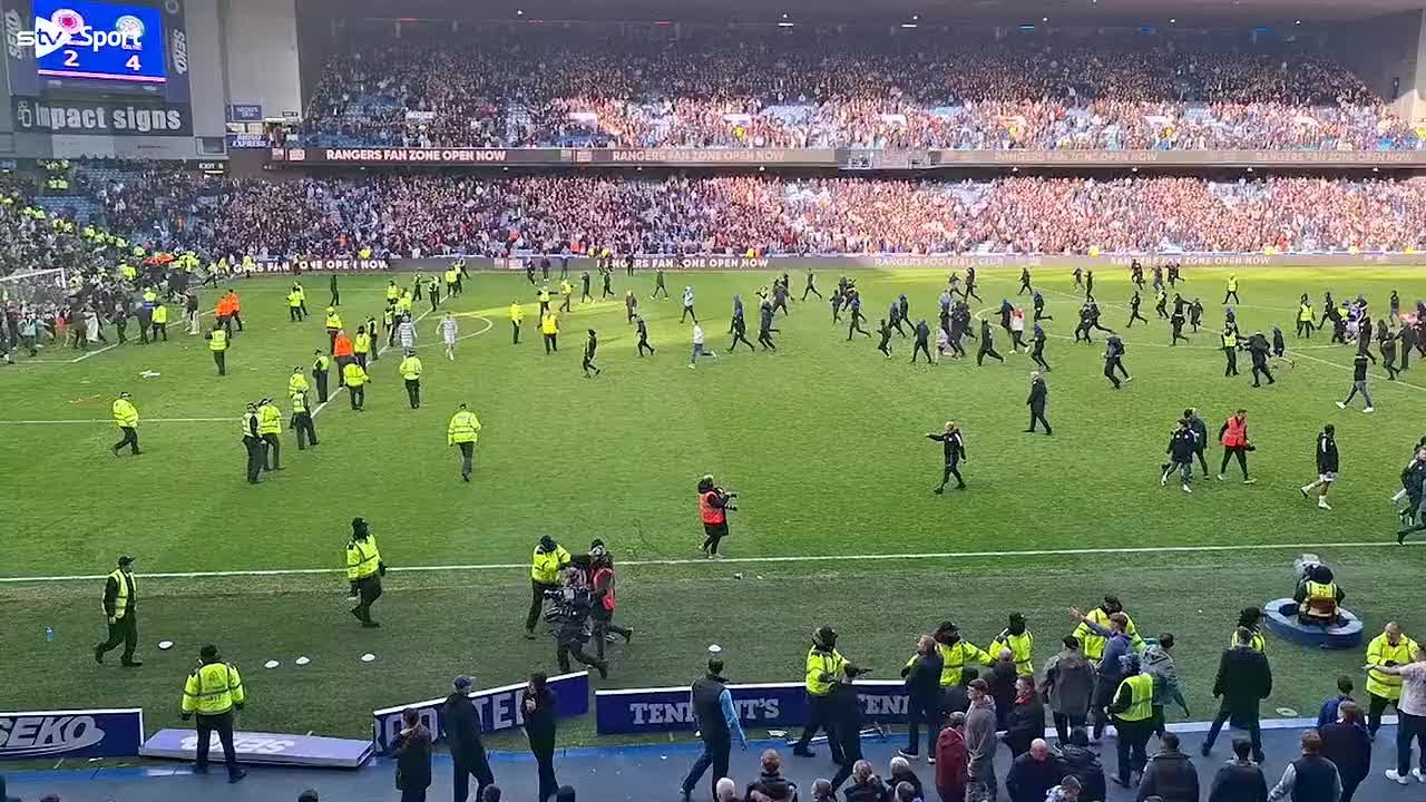 Fans clash on Ibrox pitch after Celtic knock Rangers out of cup