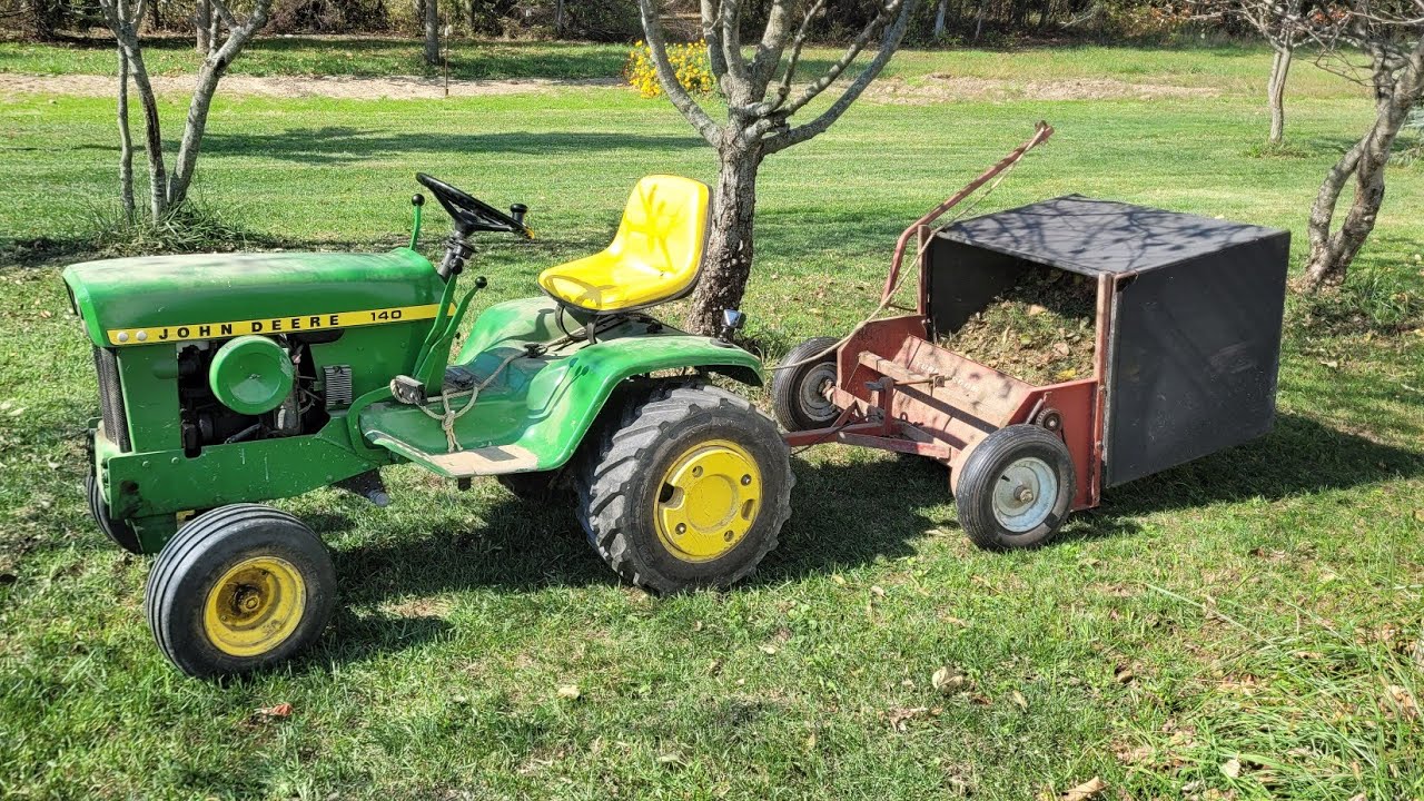 cleaning up tall thick grass with John Deere 140 acreage estate rake and turf groom 136 Lawn Sweeper