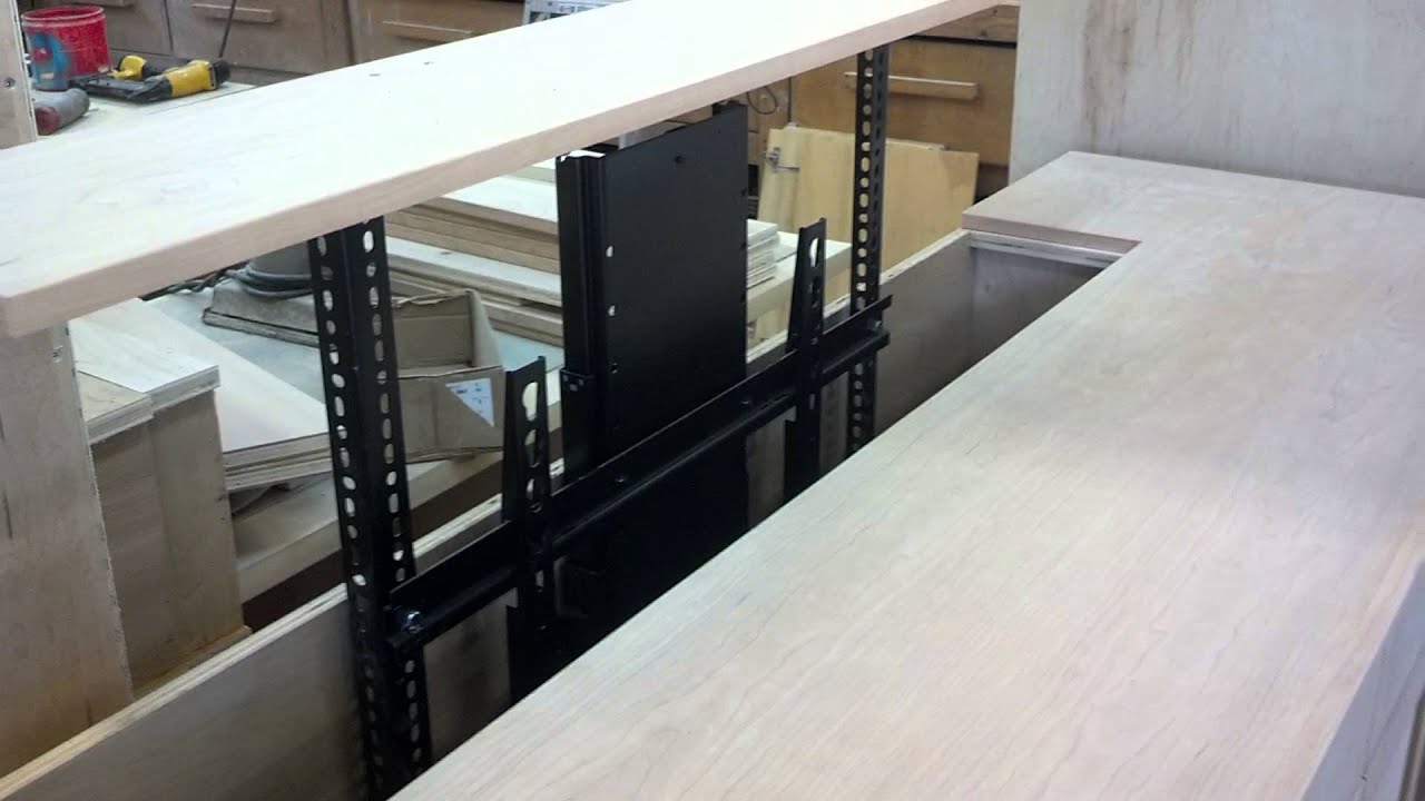 Hafele 65" TV lift in custom cherry cabinet