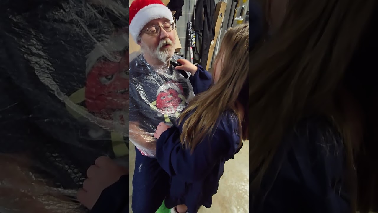 Aubrey cutting papaw Santa's beard Christmas 2025 her 3rd year doing it