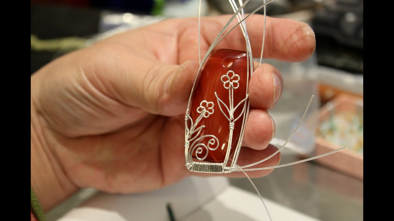 The making of a wire wrapped pendant - silver daisies on a red agate gems bead