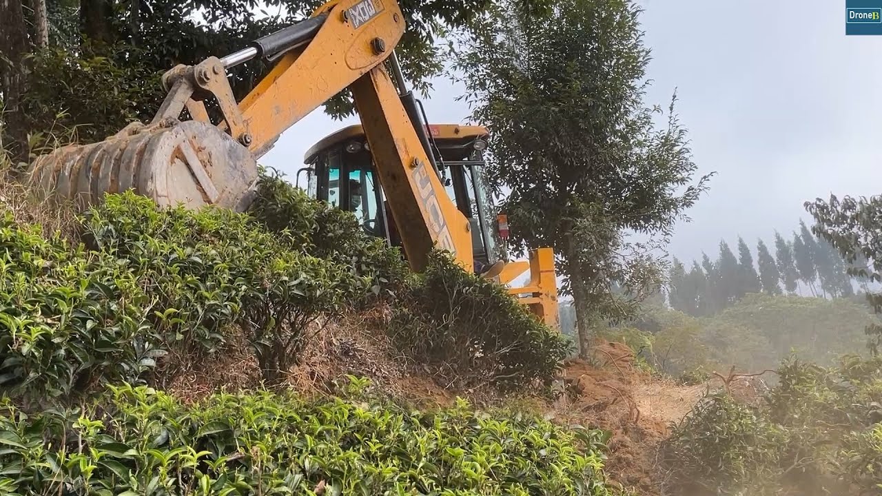 Villagers Gather as JCB Backhoe Maneuvers through High Altitude Cliff for New Mountain Road