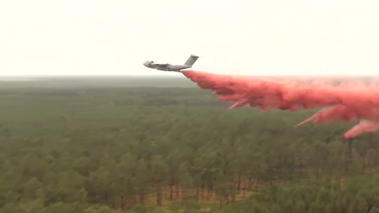 French military plane drops fire retardant over forest wildfires