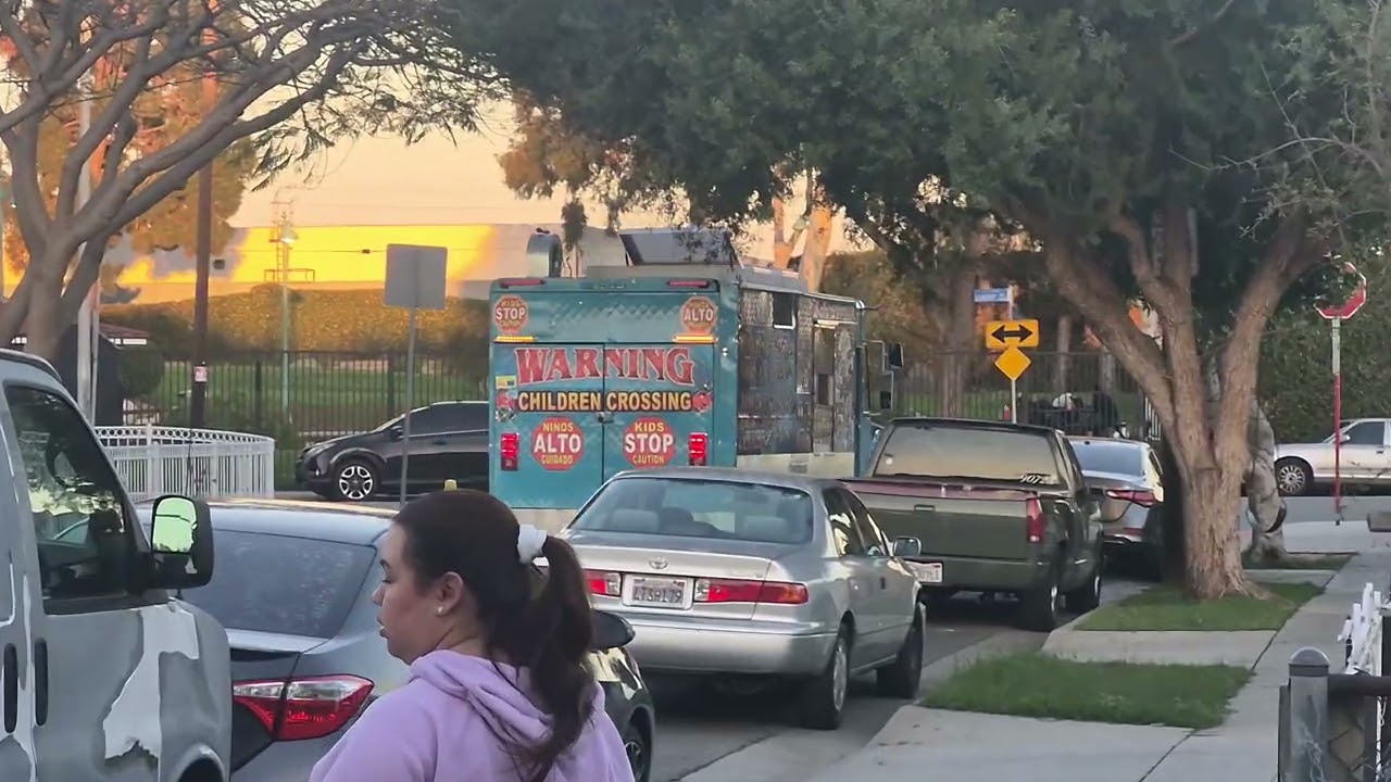2 Ice cream trucks passing by 