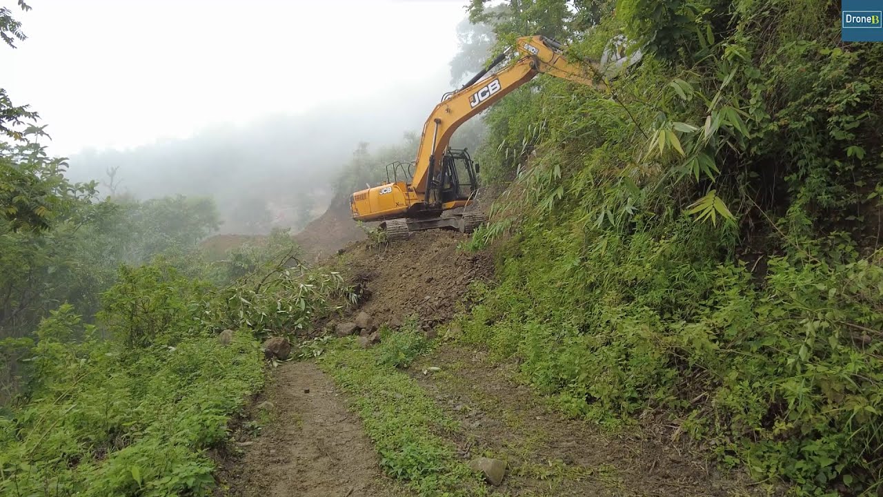 Foggy Summer Day Mountain Road Work with JCB Excavator-Cutting Out Hillside