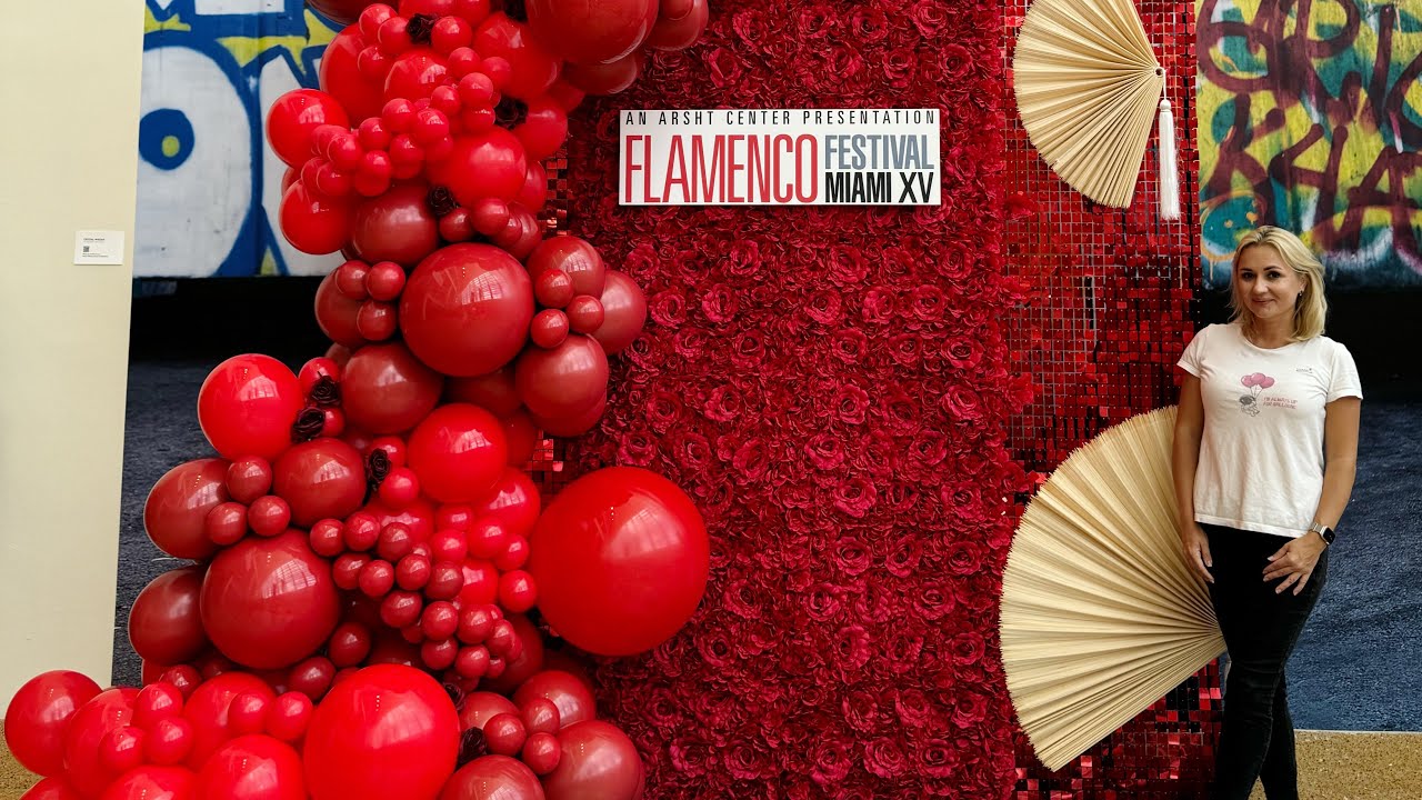 Red Flower Wall With Red Shimmer Wall and Red Balloons For a Flamenco Show