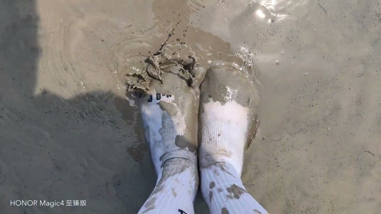 Muddy Jordan 23 White crew socks on muddy beach