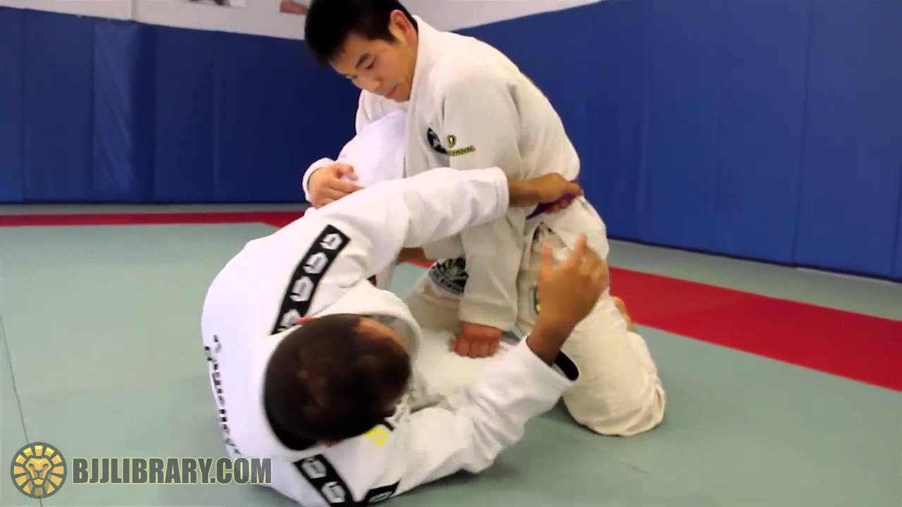 Yuri Simoes Belt Grip Backroll Sweep from Half Guard | BJJ LIBRARY