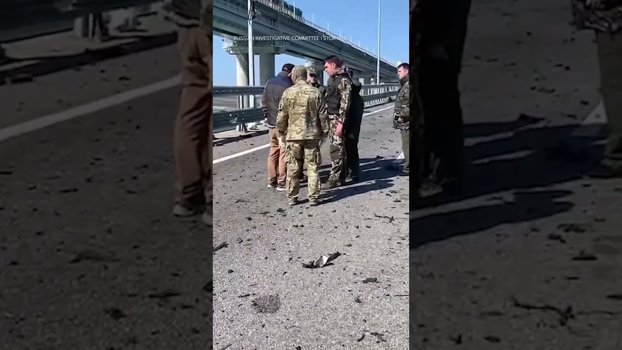 Russian military personnel survey Kerch Bridge explosion damage