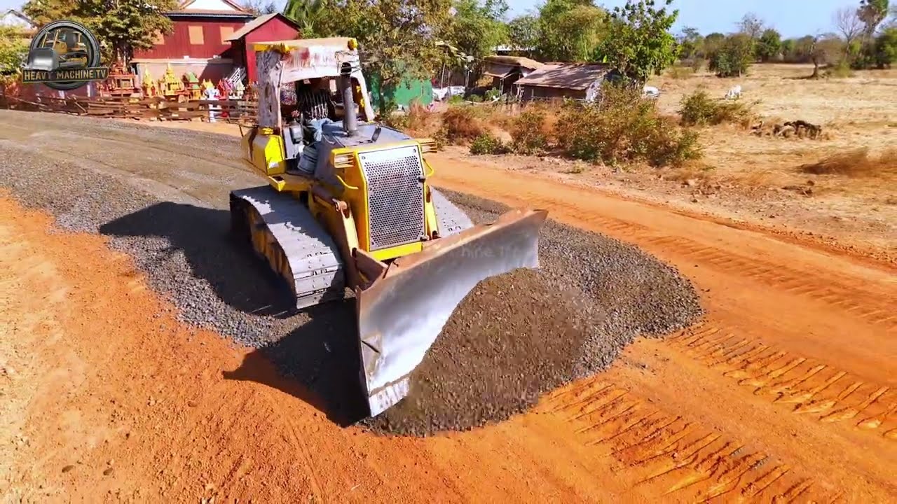 Professional Gravel Road Base Preparation Using Bulldozer While Dump Trucks Supply Massive Gravel