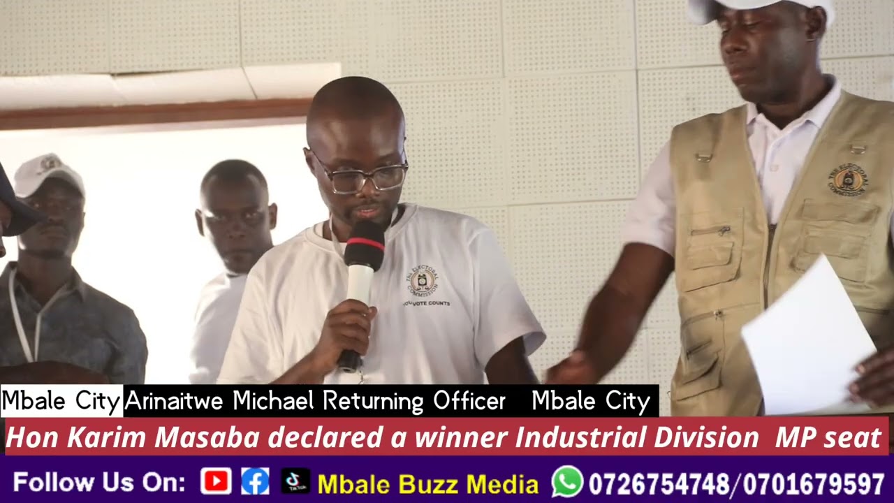 Arinaitwe Michael reading the final results at the tally centre 