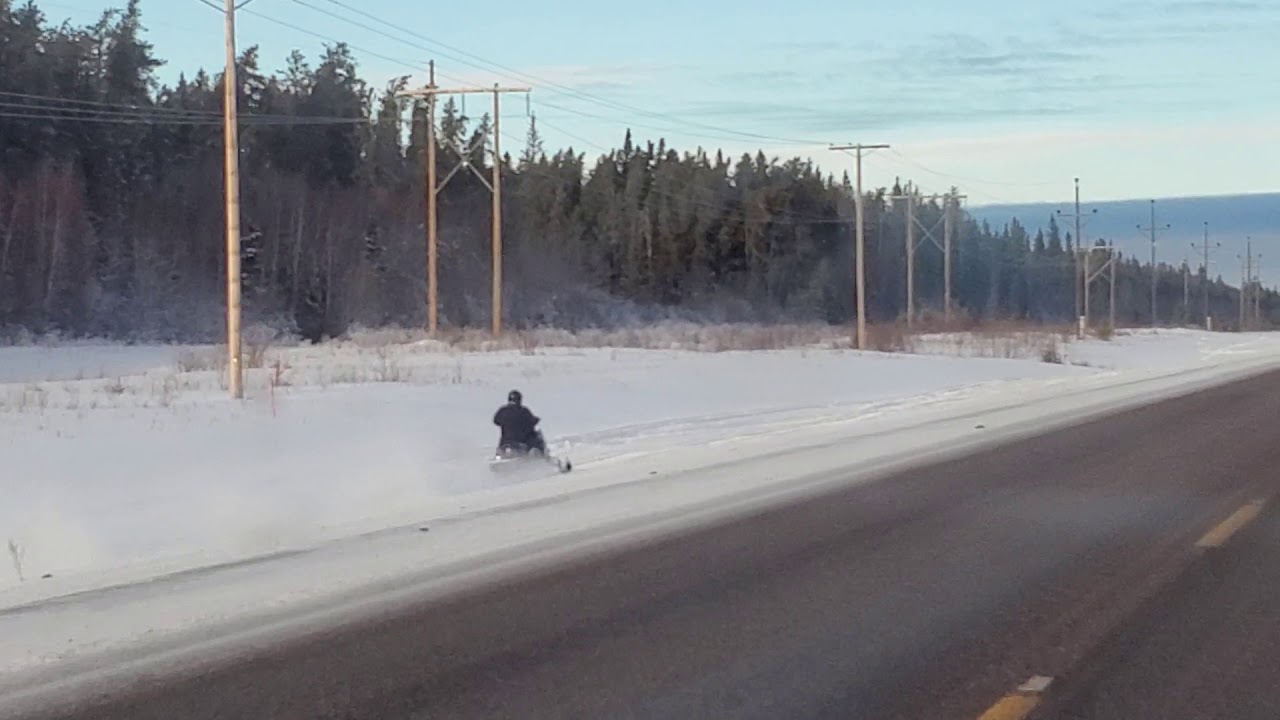 Snow mobile going really fast!!!!!winter in Saskatchewan, Canada