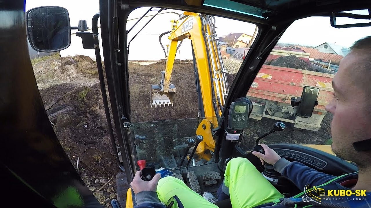JCB 8085 excavator digging clay and loading Tatra truck - cab view