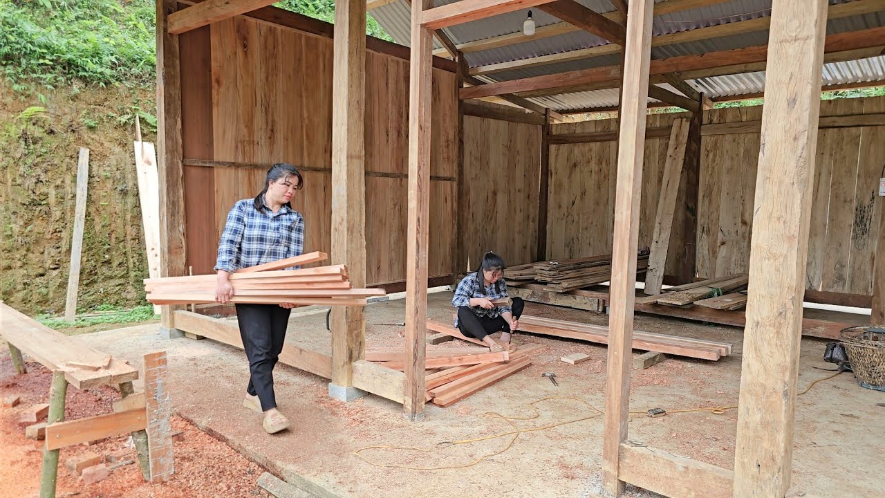 How to build a wooden house: choose wooden planks, plane the wood, and drill holes for window frames
