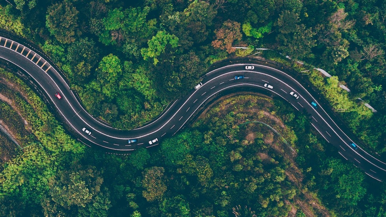 Road in the Forest. Drone flyover, spectacular view, high quality (4K Ultra-HD)