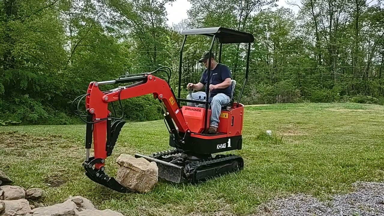 Gardner's Groundhog mini excavator testing out the rake stacking rocks.